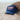 Blue trucker hat with 'SURF PARADISE' text on front