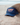 Blue trucker hat with 'SURF PARADISE' text on front